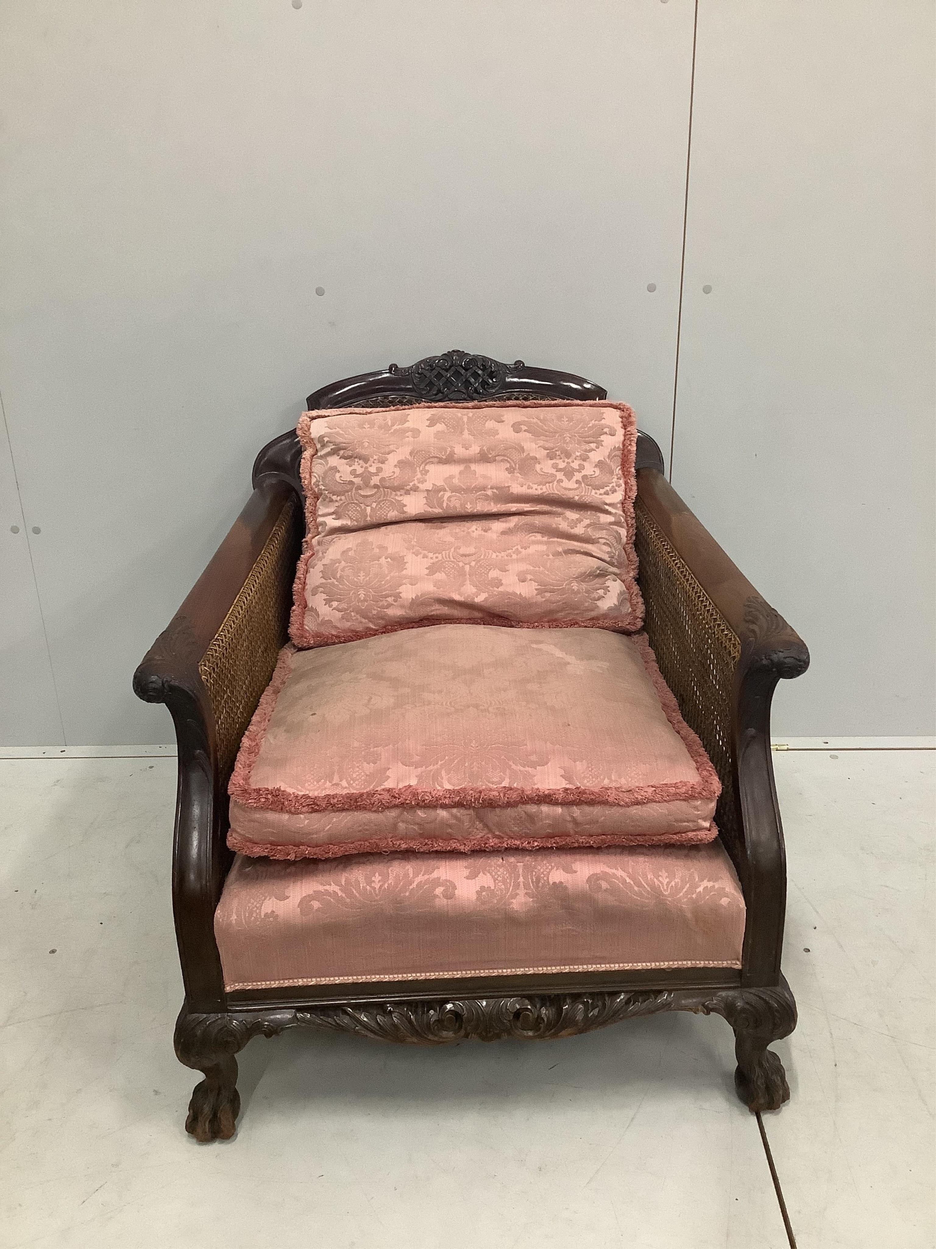 A 1930's mahogany three piece Bergere suite, with double caned arms and single caned backs. Condition - some fading with small damages to the caning